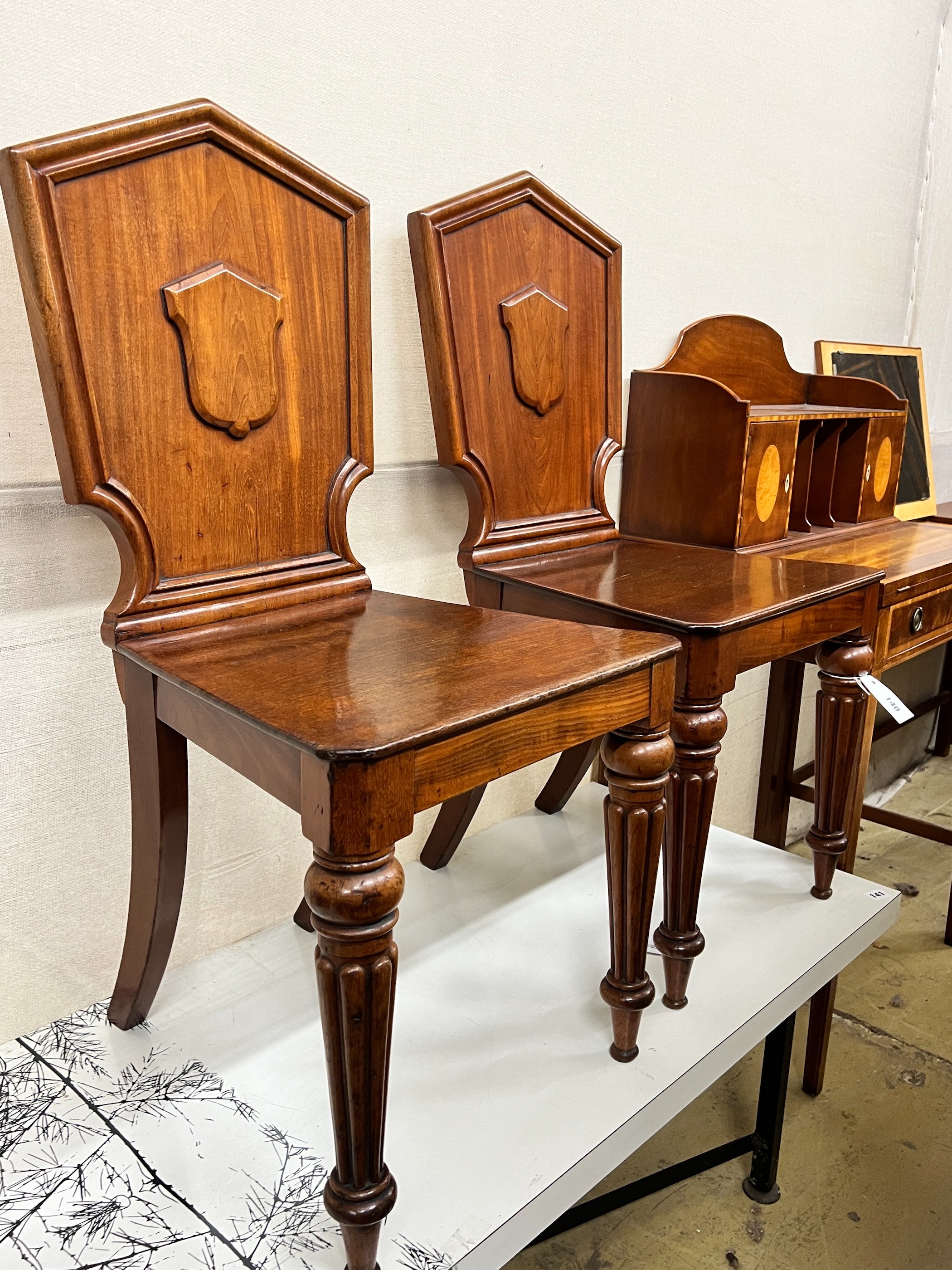 A pair of Victorian mahogany hall chairs